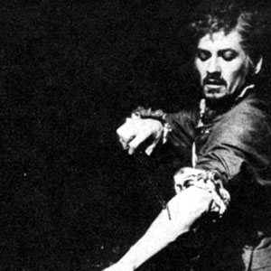 Mephistophiles (Emrys James) onbserves as Dr Faustus (Ian McKellen) inflicts the fatal self-inflicted wounding which commits Faustus's 
    soul