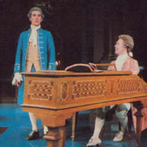 Mozart (Tim Curry) wittily transforms a pedestrian piece by Salieri (Ian McKellen) into his own music