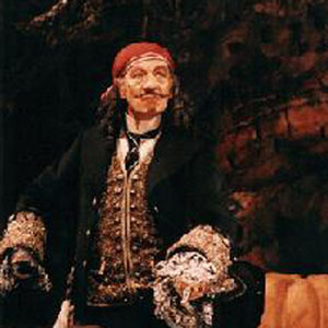 Captain Hook (Ian McKellen) hovers over the somnolent Peter Pan (Daniel Evans)