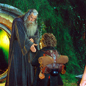 Gandalf bids farewell to Bilbo outside the door at Bag End