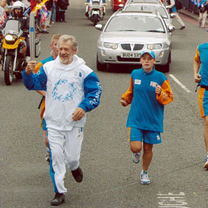 2004,   Carrying the torch across Tower Bridge, 26 June 2004  