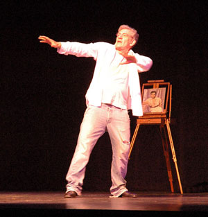 2006, A KNIGHT OUT IN LOS ANGELES (2006): Magneto lifts the Golden Gate Bridge, Rehearsal.  Note, behind him is an original oil painting of John Derek (1956) by James Whale.  - Photo by Keith Stern