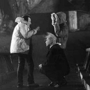 On the drawbridge to the Keep, director Michael Mann (L) gives last-minute instructions to Ian McKellen (centre), as the wind-machines blow and the camera is ready to turn