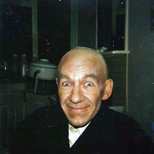 Death-defying joviality in a bald cap