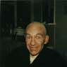 Death-defying joviality in a bald cap