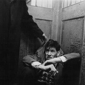 Walter (Ian McKellen) cowers in fear of  bullies in the factory elevator.