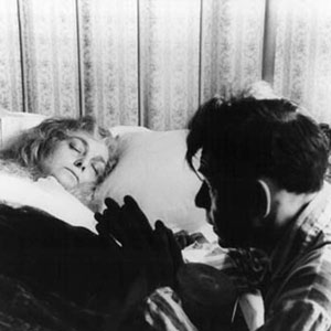 Walter (Ian McKellen) prays at the bedside of his dead mother (Barbara Jefford) for Jesus to return her to him.