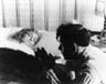 Walter (Ian McKellen) prays at the bedside of his dead mother (Barbara Jefford) for Jesus to return her to him.