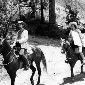 Riding with amanuensis  Brett (Penelope Keith) on a painting expedition.
<BR><BR><I>Lawrence was a considerable amateur painter � </I>Priest of Love<I> opened with the banning of a London exhibition of his oils, on the grounds of obscenity.
Acting on horseback is not easy � the animal is so resolutely itself, unabashed by the camera�s attention, whilst the rider has to be in control, yet relaxed enough to remain in character.  I had learnt to ride safely when I was initially cast as Ned Kelly for Tony Richardson�s film about the Australian outlaw.  Mick Jagger eventually played the part.</I>